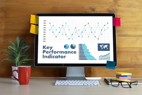 KPI acronym (Key Performance Indicator) Business team hands at work with fina Stock Photos