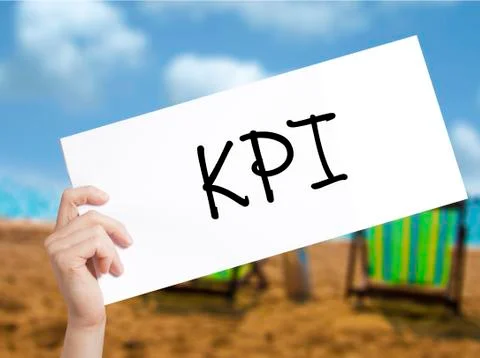 KPI (Key Performance Indicator) Sign on white paper. Man Hand Holding Paper w Stock Photos