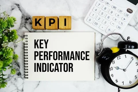 KPI Key Performance Indicator text with calculator and alarm clock on marbl.. Stock Photos
