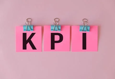 KPI text on pink paper for notes on the wall. Business concept Stock Photos