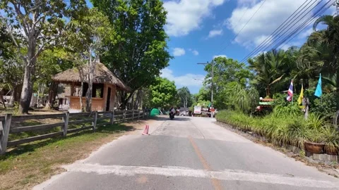 KRABI, THAILAND - MAY 11, 2026: Scenic view of the entrance road and parkin.. Stock Footage 334654591