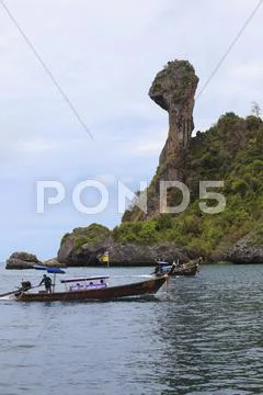Krabi,thailand-apri l16,2013: boats taking group of visitor past koh kai isla Stock Photos