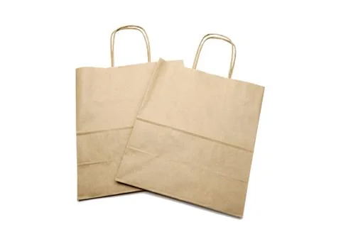 Kraft bag, an empty brown paper bag on an isolated white background. The concept Stock Photos