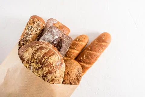 Kraft bag filled with various types of bread from the bakery. Zero waste, e.. Stock Photos