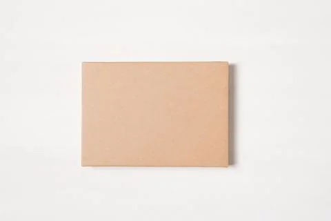 Kraft brown rectangular gift box on a light background 스톡 사진