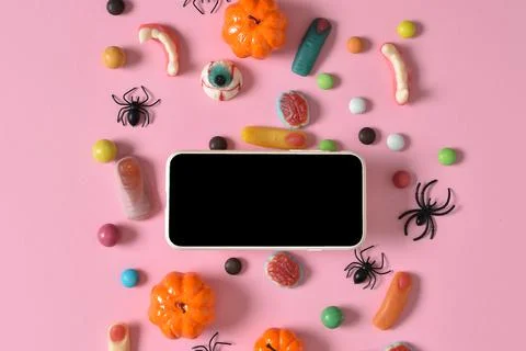 Kraft envelope with empty paper on the background of various sweets on a pink Stock Photos