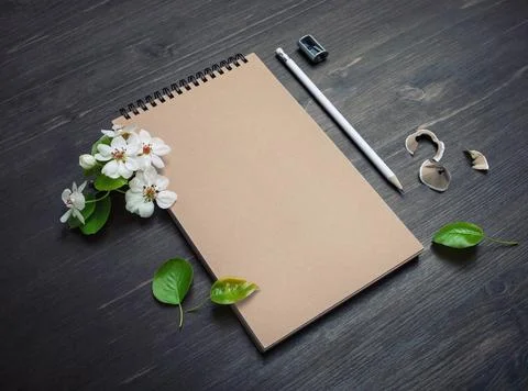 Kraft notepad, pencil, sharpener, flowers Stock Photos