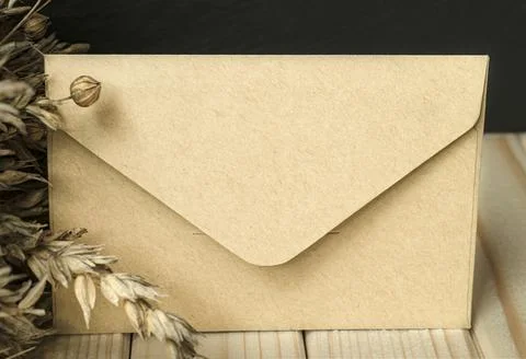 Kraft paper envelope front view on table Stock Photos