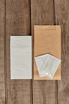 Kraft paper packaging, wet wipes sachets and paper napkins for food delivery Stock Photos