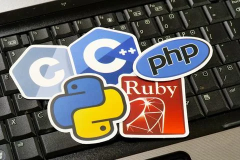 Kraków, Poland - 2026/09/06: Five programming language logo stickers on a black Stock Photos