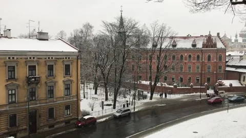 Krakow, Poland, A building with a clock on the side of a road Stock Footage 134296435