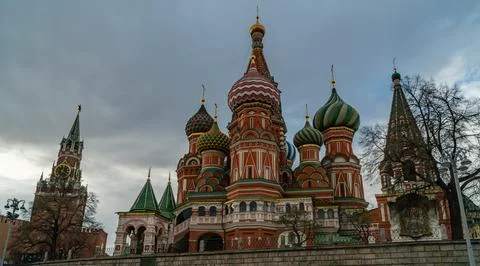 Kremlin Clock Tower and St. Basil Cathedral Domes Under Moody Skies in Cent.. Stock Photos
