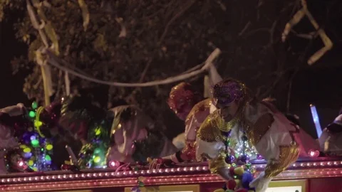 Krewe members throw beads at Mardi Gras Parade in New Orleans, LA (Orpheus) Stock Footage