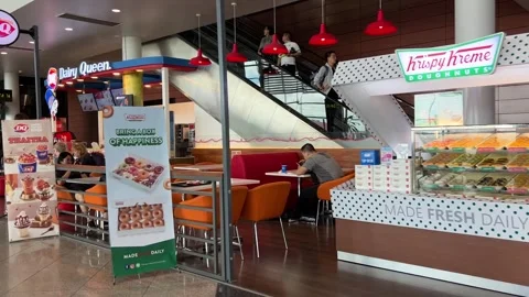 Krispy Kreme Doghnut and Diary Queen at Phnom Penh Airport Cambodia Stock Footage 250734403