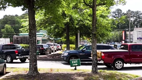 Krispy Kreme doughnuts long line of cars in drive thru Stock Footage 237728490