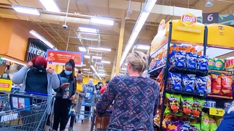 Kroger grocery store interior groups of people wearing face masks at the back Stock Footage 144014977