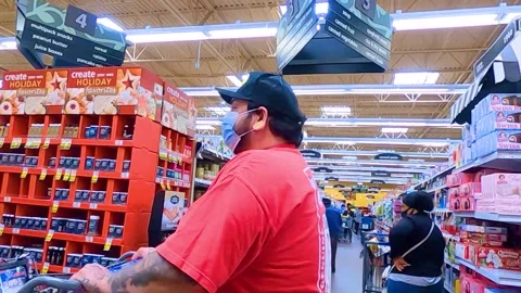 Kroger grocery store interior people wearing face masks pass by camera Stock Footage 144014963