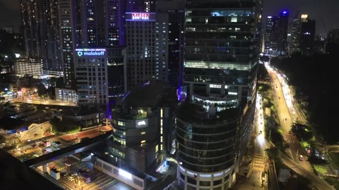 Kuala Lumpur mid-air view of city urban highrise towers highways traffic night Stock Footage 288319279