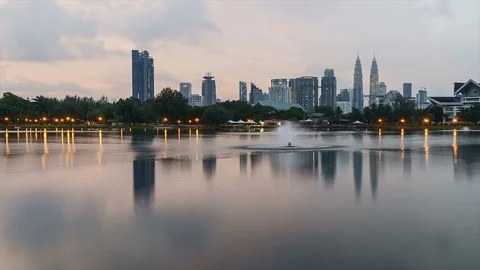 Kuala Lumpur skyline seen from Taman Tasik Titiwangsa during sunrise/sunset Stock Footage 85679727