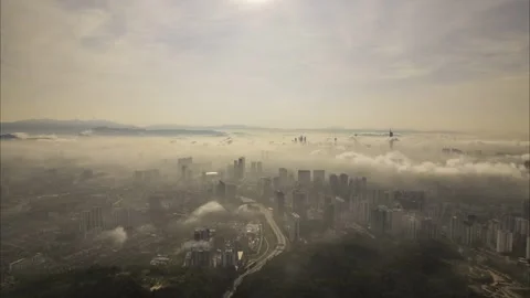Kuala Lumpur at sunrise with low-lying clouds and morning mist  Stock Footage 341409698
