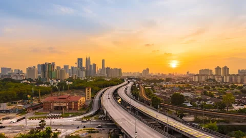Kuala Lumpur Time Lapse: Sunset of cityscape during a golden sunset with moonset Stock Footage 225751220