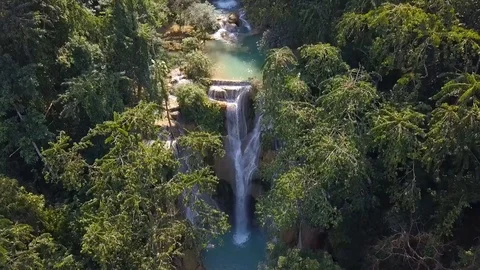 Kuang Si Falls waterfall and emerald pool in jungle forest in Laos. Stock Footage