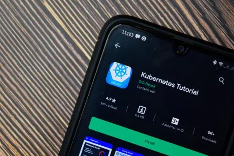 Kubernetes Tutorial dev app with magnifying on Smartphone screen. Stock Photos