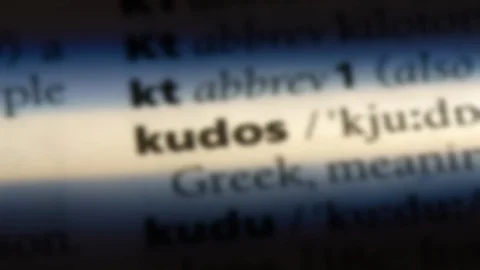 Kudos word in a dictionary. Stock Footage 99561995