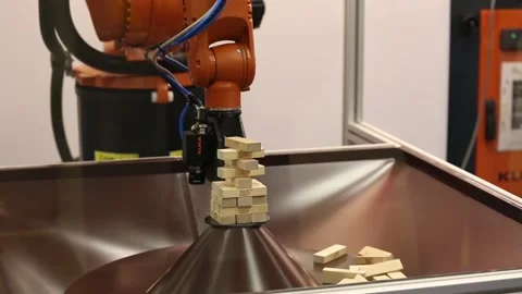 Kuka robot arm playing Jenga wooden blocks 库存影片 90750051