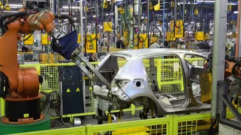 Kuka robots weld car on conveyor line of factory AutoVAZ. Slowmotion Stock-Footage 73485405