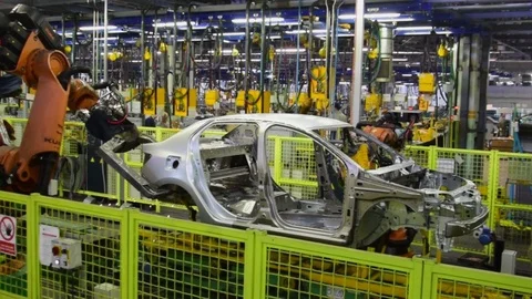 Kuka robots weld a car on the conveyor line Stock Footage 73485503