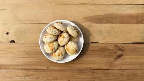 Kulcha e Khataye Biscuits on a White Plate with Wooden Background. Stock Footage 276897917