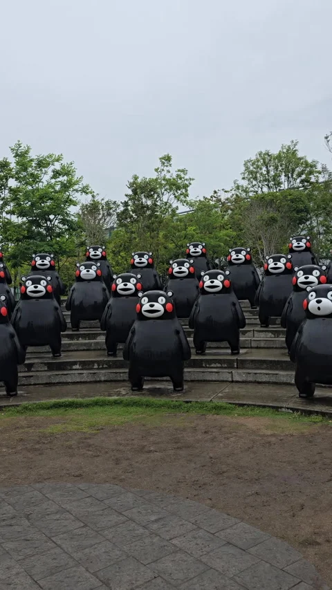 Kumamon mascot statues stand in rows at Yatsushiro Port, depicting the popular Stock Footage 327614606