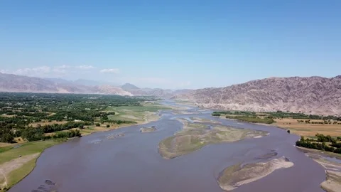 The Kunar River flows by Afghanistan's Kama District Stock Footage 274868559