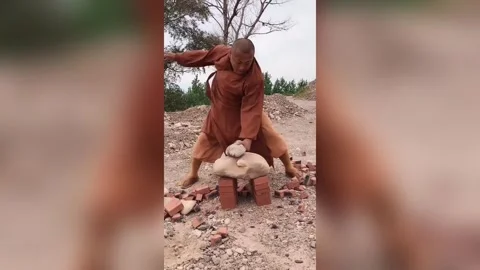 Kung fu monk uses two fingers to break cobblestone at Shaolin Temple Stock Footage 272911221