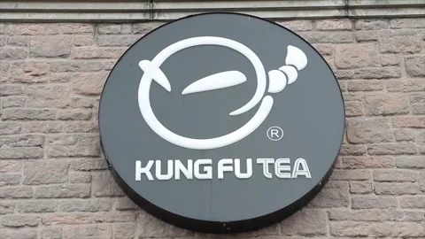 Kung fu tea circle cylinder logo on side of store storefront in summer, black Stock Footage 250279561