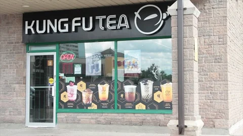 Kung fu tea store storefront restaurant front entrance with doors and windows Stock Footage 250279543