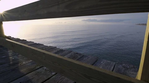Kure beach pier railing sun flare Stock Footage 99281946