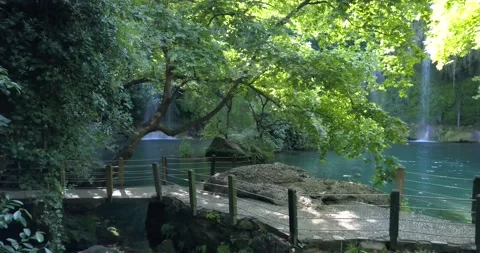Kursunlu waterfall on the background of a small bridge in the park, 4k Stock Footage 138004053