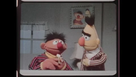 Kuwait 1970s: Ernie the Muppet talks with Muppet Bert. Bert and Ernie talk as Stock Footage 324571808