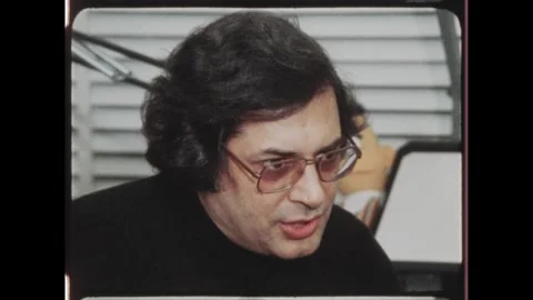 Kuwait 1970s: Man is interviewed seated with Bert and Ernie puppet in Stock Footage 324571837