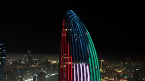 Kuwait flag illuminated on modern skyscraper facade at night city skyline Stock Footage 329611557