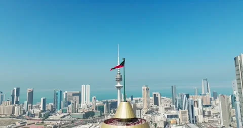 Kuwait flag waving in the sky with Kuwait buildings in the background Stock Footage 266979904
