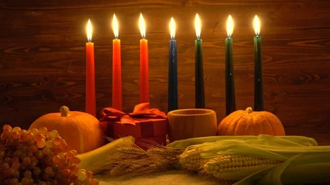 Kwanzaa festive concept with burning seven candles red, black and green decor Stock Footage