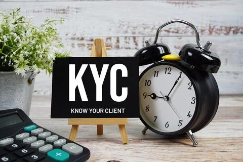 KYC Know Your Client text with alarm clock and calculator on wooden backgroun Stock Photos