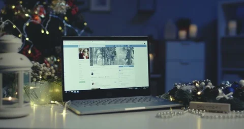 Kyiv - December 2018: Laptop computer with Facebook Christmas page on its screen Stock-Footage 99802371