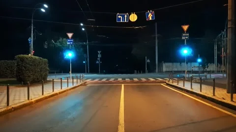 Kyiv empty street at night under curfew, red traffic lights in military loc.. Stock Footage 318541078