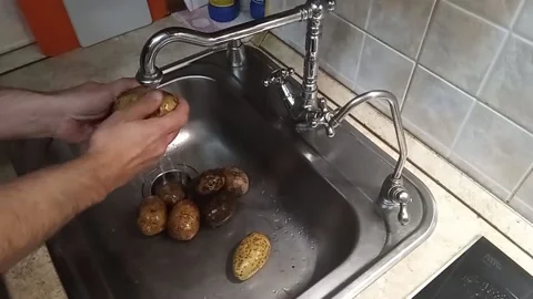 Kyiv. washing potatoes Stock Footage 225123033