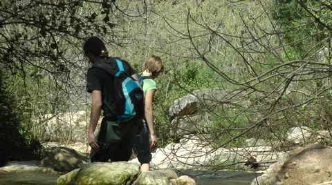 Kziv river at spring. People walking across the spring. Stock Footage 2606697