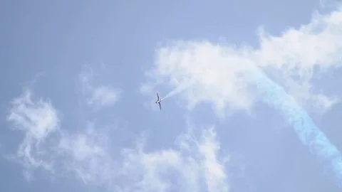 The L-29 jet plane dives down leaving a white trace behind it. Stock Footage 79761904